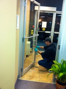 One of our OptiClean staff cleaning a glass entry door